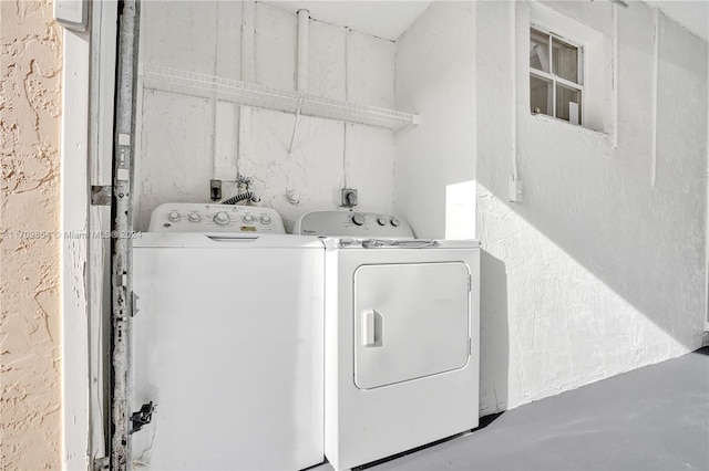 clothes washing area featuring independent washer and dryer