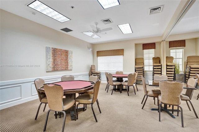 dining room featuring ceiling fan and light colored carpet