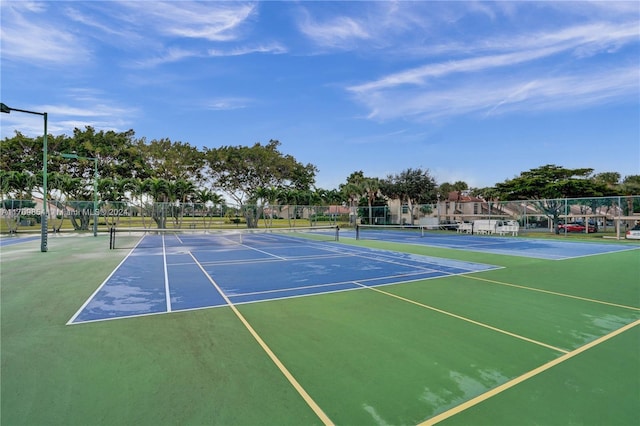 view of tennis court with basketball hoop