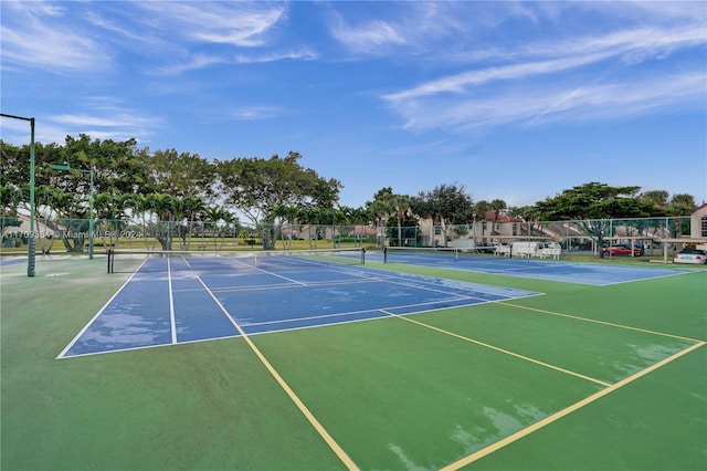 view of tennis court featuring basketball hoop