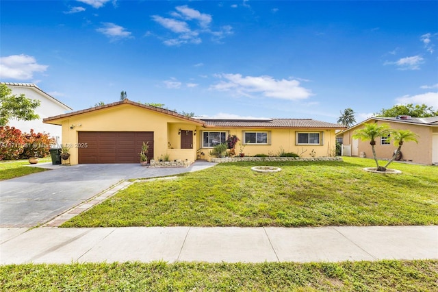 ranch-style home featuring a garage and a front yard