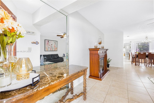 tiled home office with ceiling fan with notable chandelier