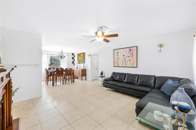 living room featuring light tile patterned floors and ceiling fan with notable chandelier