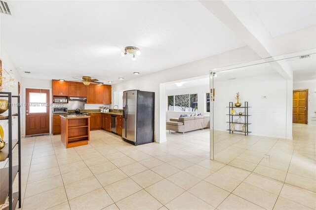 kitchen featuring stainless steel appliances, a healthy amount of sunlight, and light tile patterned flooring