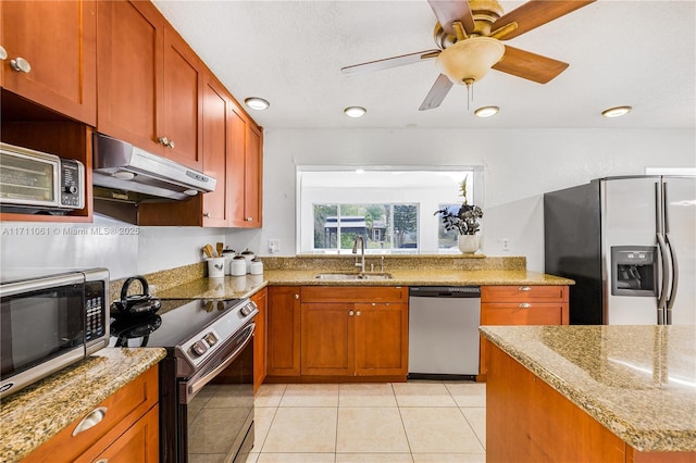 kitchen featuring sink, stainless steel appliances, light stone counters, a textured ceiling, and light tile patterned flooring