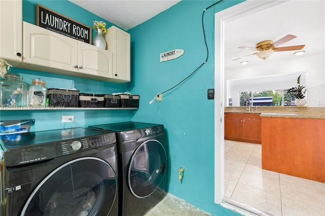 washroom featuring light tile patterned flooring, washing machine and clothes dryer, sink, cabinets, and ceiling fan