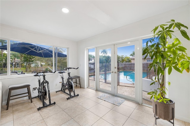 workout area with french doors and light tile patterned floors