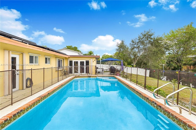 view of pool with french doors