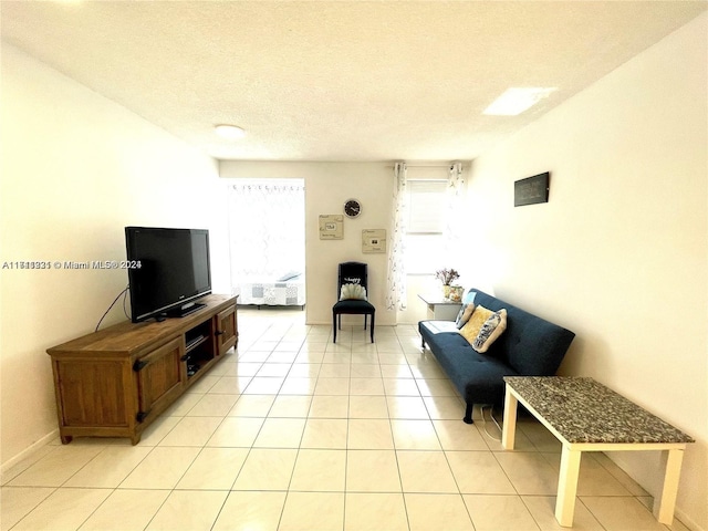 living room with light tile patterned floors and a textured ceiling