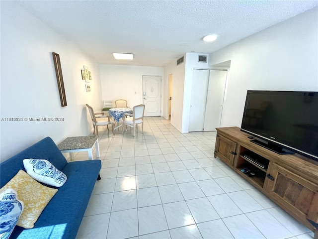 tiled living room with a textured ceiling