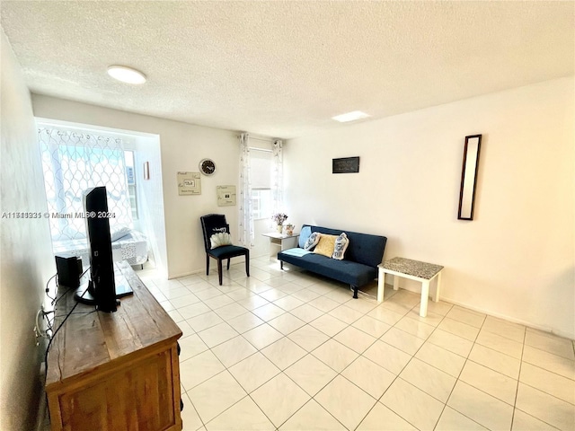 tiled living room with a healthy amount of sunlight and a textured ceiling