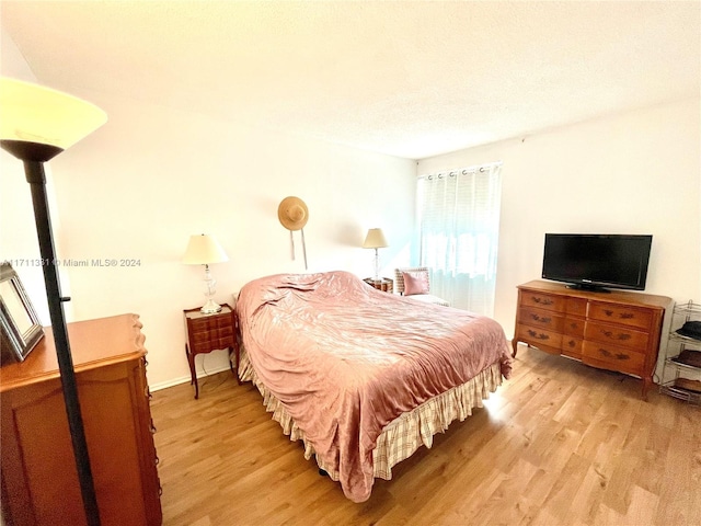 bedroom with light wood-type flooring