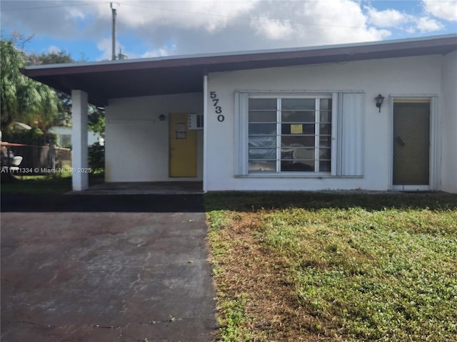 doorway to property featuring a yard