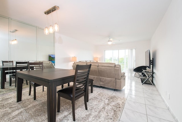 tiled dining space with ceiling fan