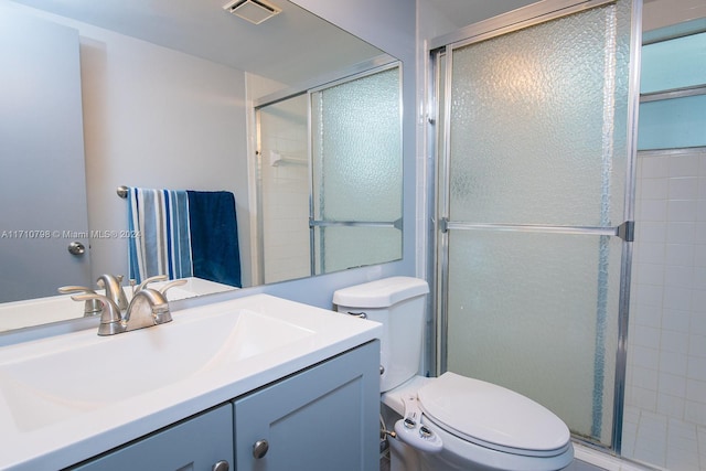 bathroom with vanity, toilet, and walk in shower