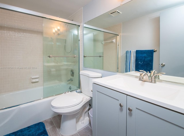 full bathroom with shower / bath combination with glass door, vanity, and toilet