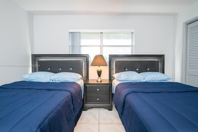 bedroom with light tile patterned floors