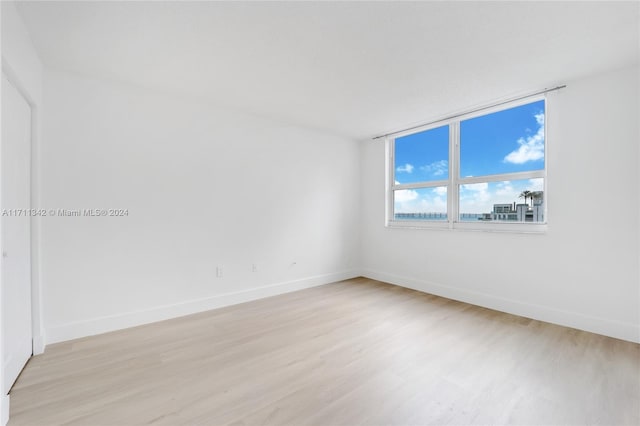 empty room with light hardwood / wood-style floors