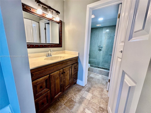 bathroom featuring toilet, vanity, and walk in shower