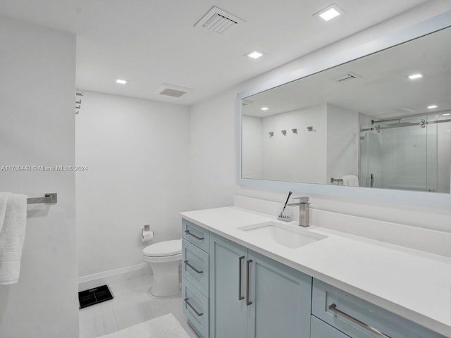 bathroom with vanity, toilet, and walk in shower