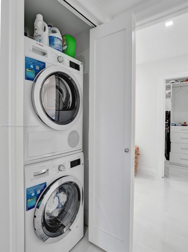 clothes washing area featuring stacked washer / drying machine