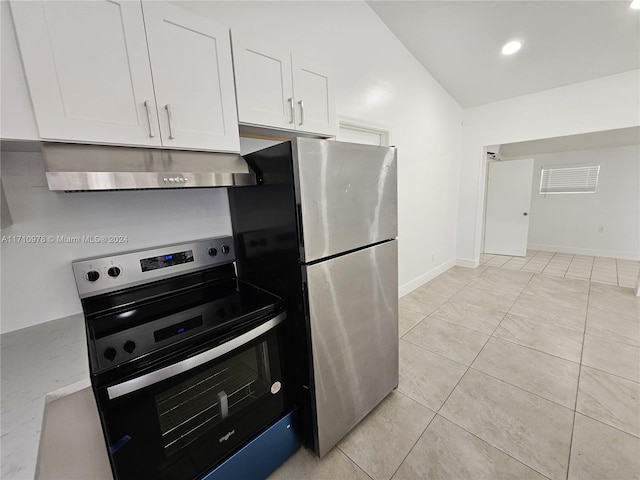 kitchen featuring white cabinetry, light tile patterned flooring, lofted ceiling, and appliances with stainless steel finishes