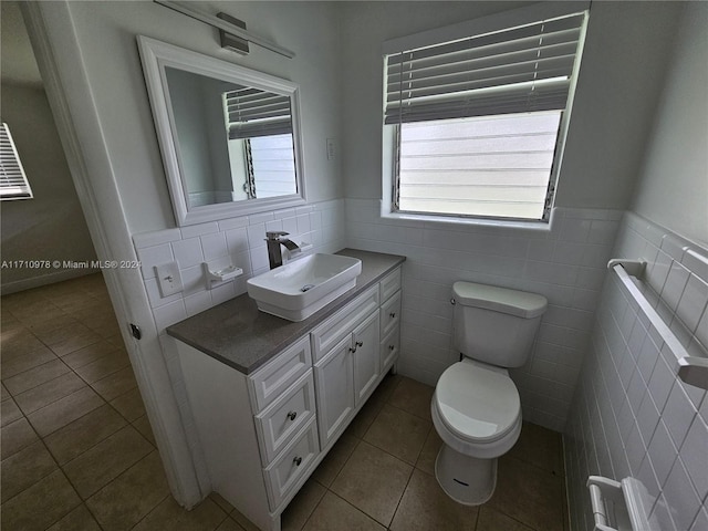 bathroom featuring a healthy amount of sunlight and tile walls