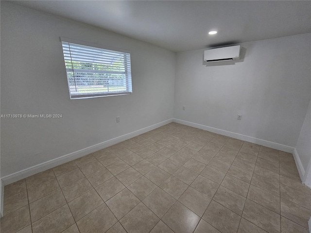 spare room with light tile patterned floors and a wall mounted AC