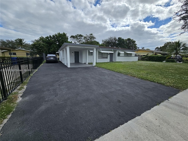 view of front facade with a front yard and a carport