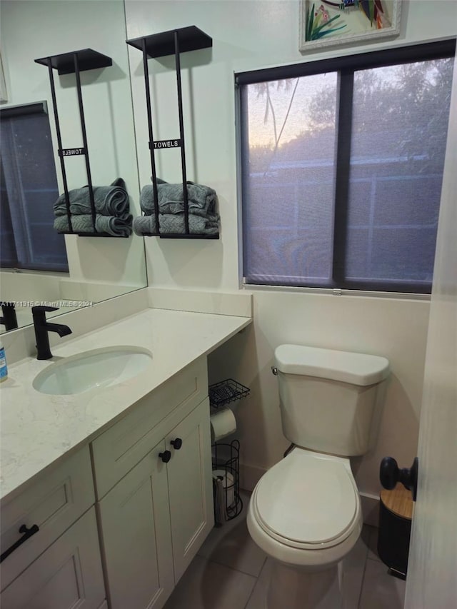 bathroom featuring tile patterned floors, vanity, and toilet