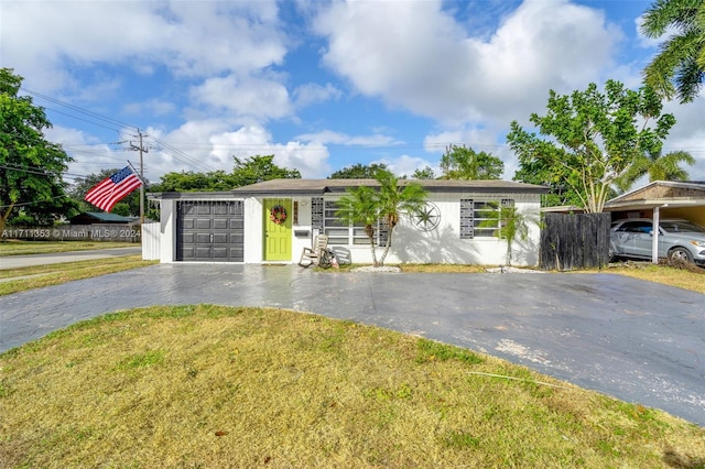 ranch-style house with a garage and a front lawn