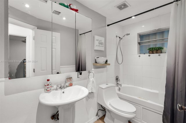 full bathroom with shower / bath combination with curtain, toilet, and sink