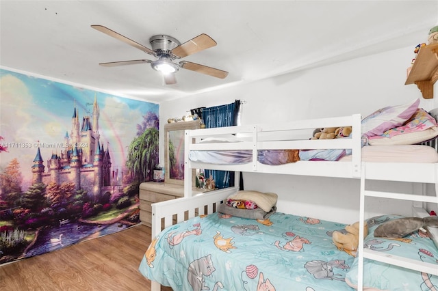 bedroom with ceiling fan and hardwood / wood-style flooring