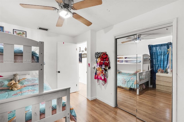 bedroom with a closet, ceiling fan, and light hardwood / wood-style flooring