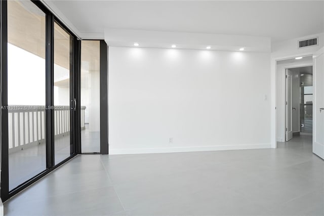 unfurnished room featuring floor to ceiling windows