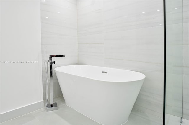 bathroom featuring tile patterned floors and a tub