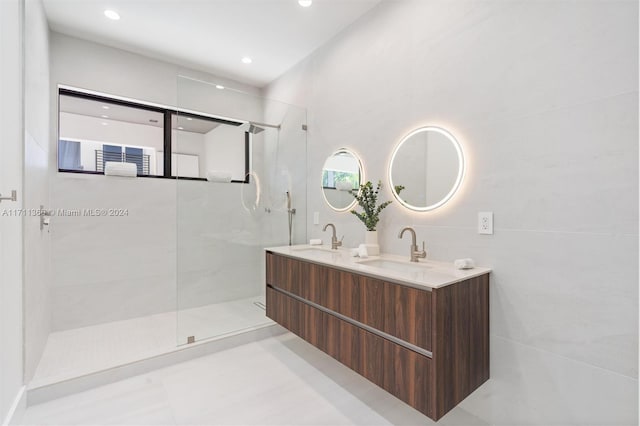 bathroom with tiled shower and vanity