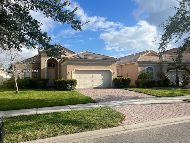 view of front facade with a garage and a front yard