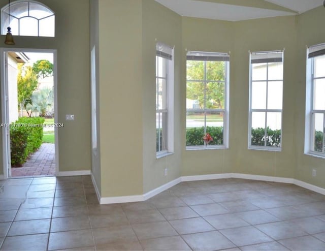 unfurnished room with light tile patterned flooring