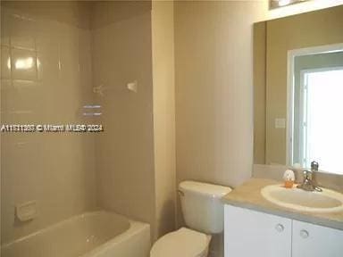 full bathroom with vanity, tub / shower combination, and toilet