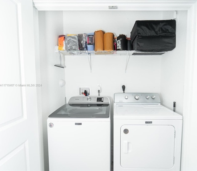 laundry room with washing machine and clothes dryer