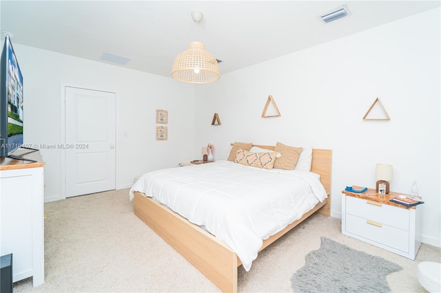 bedroom featuring light carpet