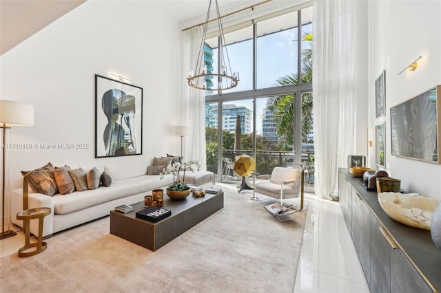 tiled living room featuring a notable chandelier and a high ceiling