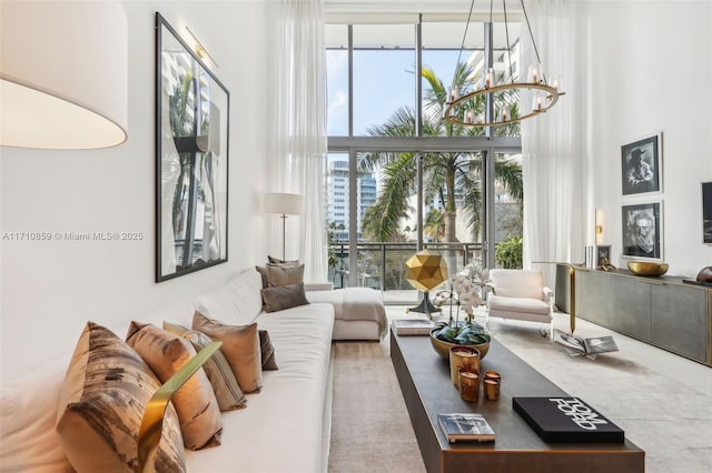 living room featuring a towering ceiling and a chandelier