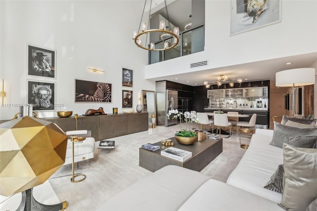 living room featuring a notable chandelier and a high ceiling