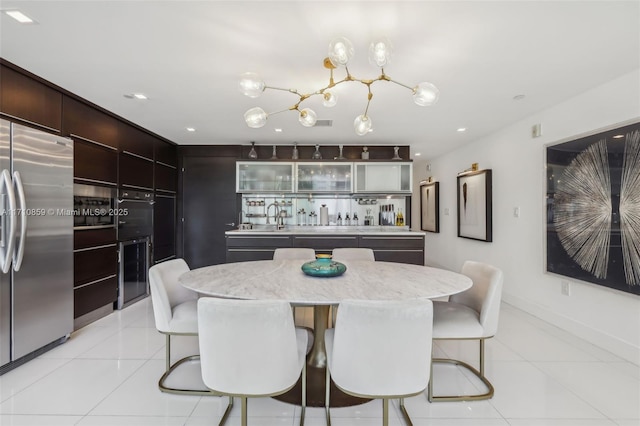 dining space featuring light tile patterned floors and sink