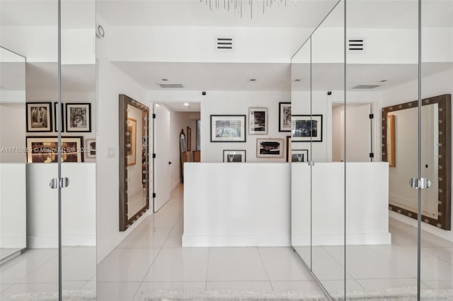 interior space with white cabinets and light tile patterned floors