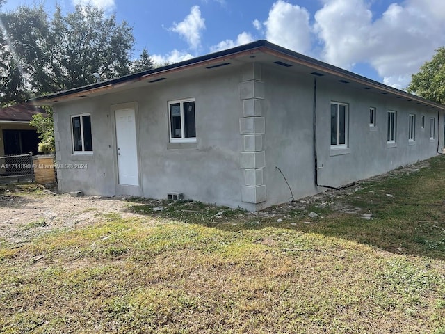 rear view of property with a lawn