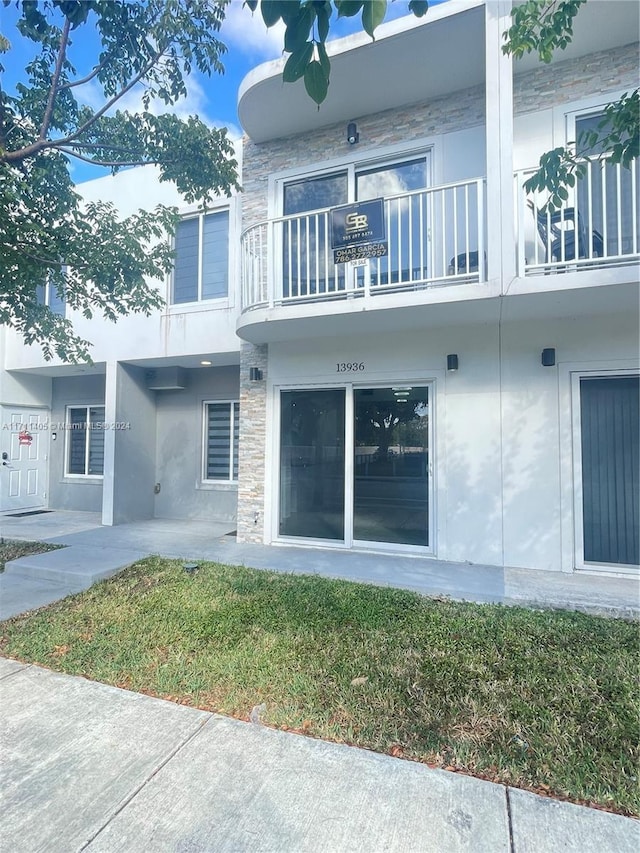 rear view of property with a lawn