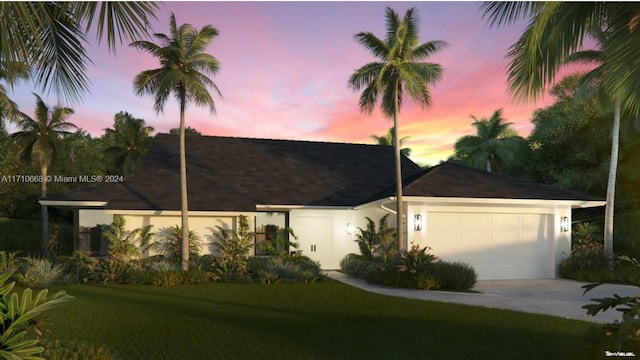 view of front facade featuring a garage and a lawn